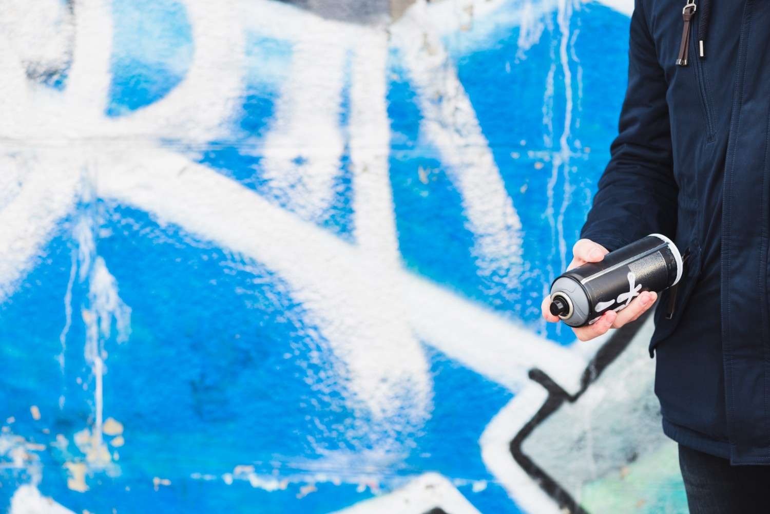 Professional swimming pool maintenance technician cleaning pool water